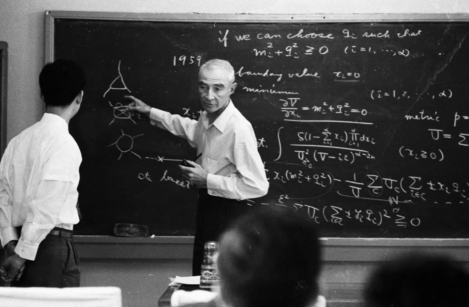 Academic blackboard with mathematical equations and diagrams